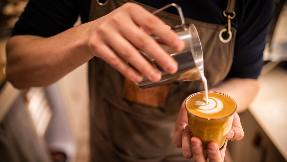 Barista making coffee cup latte art