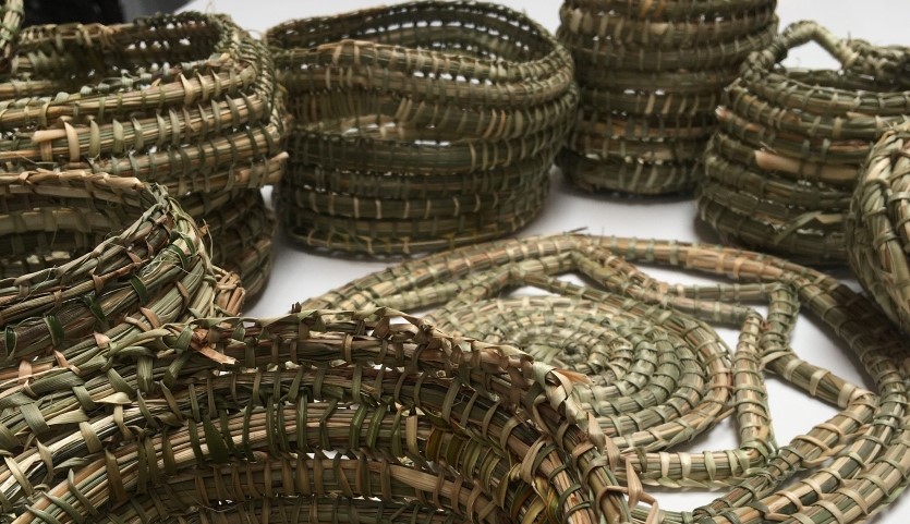 several brown baskets made of fibre rope coiled into spirals sit on a white background