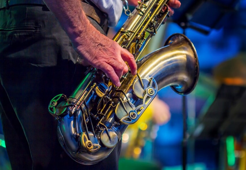 Saxophone being played by male musician.