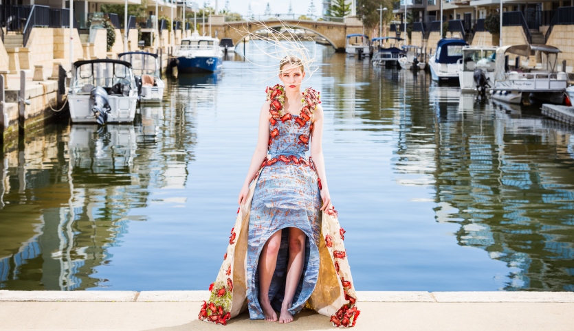Wearable Art Mandurah 2021 garment called The Red Army modelled in front of a Mandurah canal