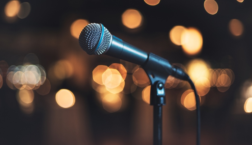 A microphone with blurred lights in the background.