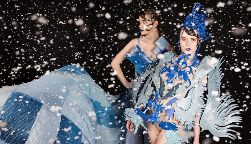 Two women modelling wearable art in shades of blue.