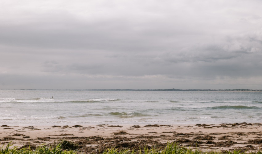 Landscape image of a beach on an overcast day