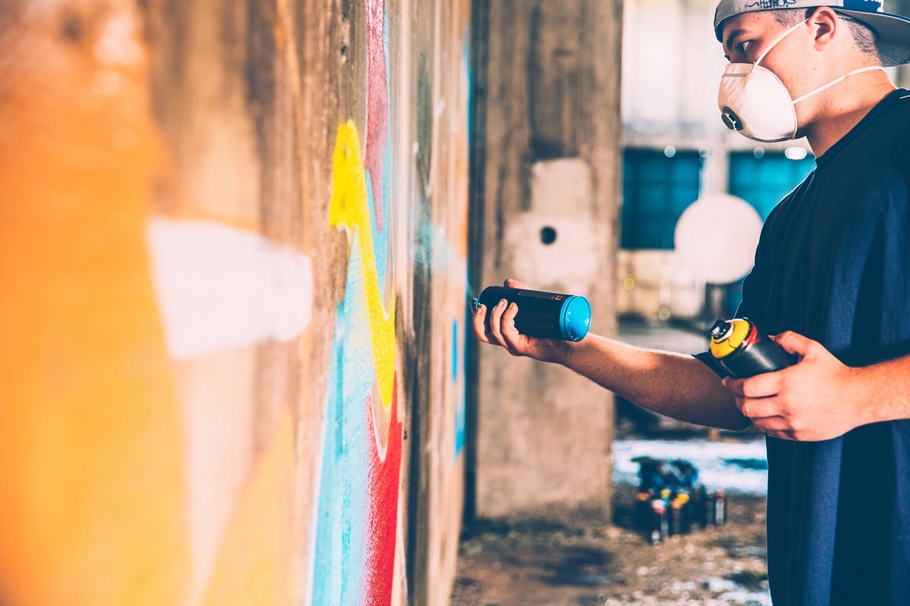 Man spray painting on a wall