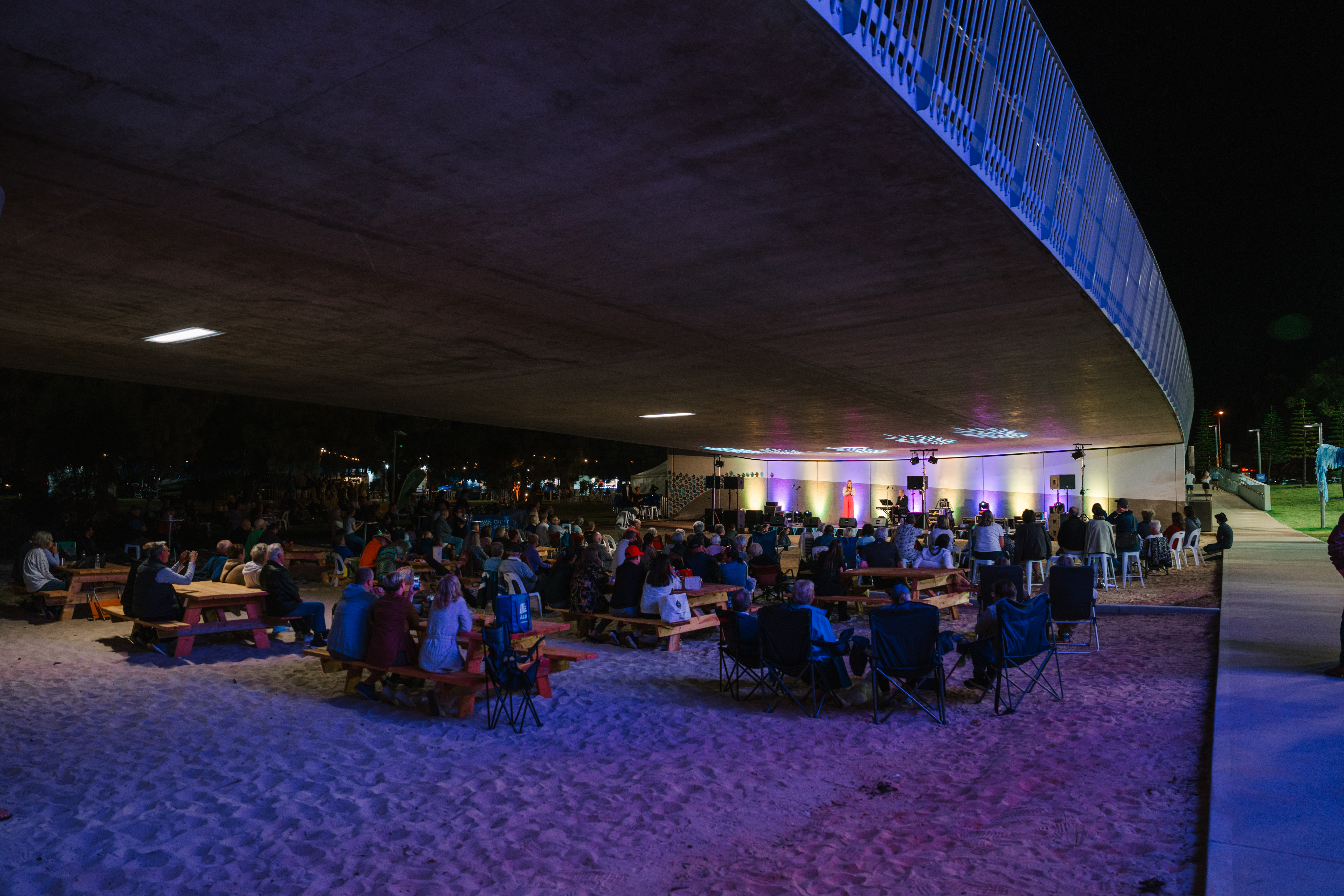 Photo of crowd listening to music underneath the Mandurah Bridge 
