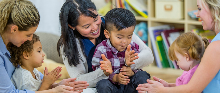 Clapping and singing parents with their children
