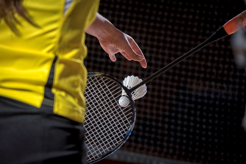 Close-up image of a person playing badminton