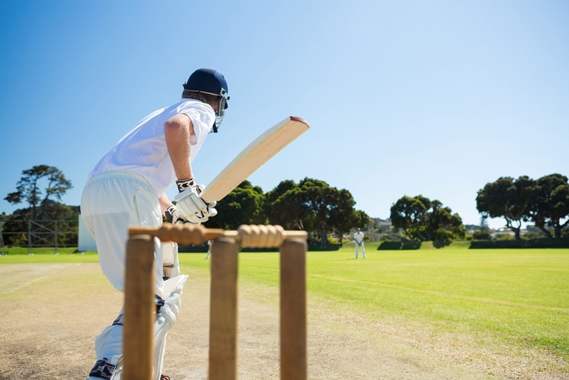 Outdoor cricket game looking through the wickets to the batsman