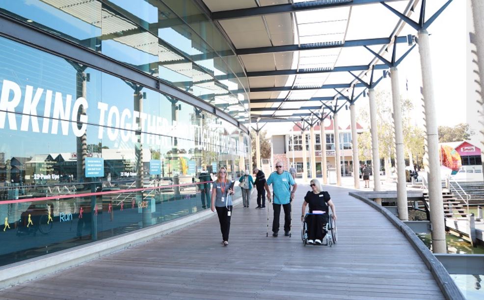 Image of front of MPAC building with people on boardwalk