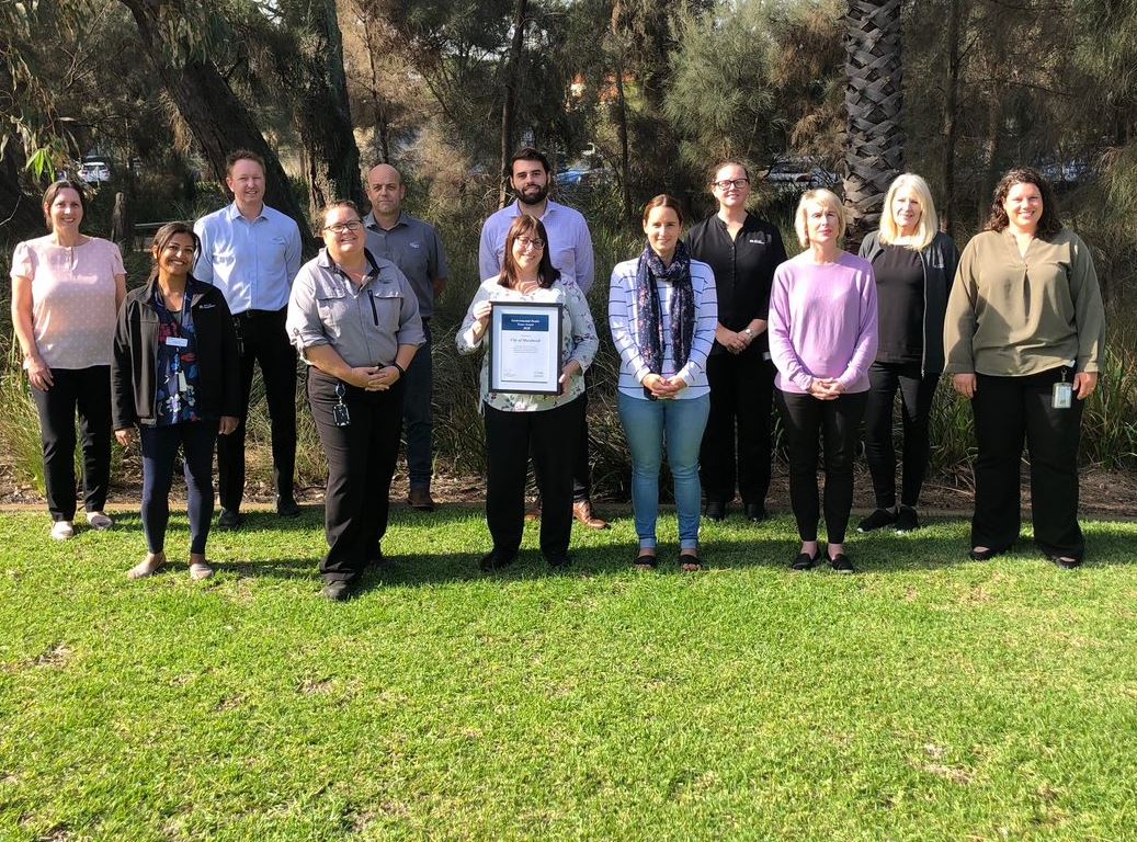 City Health Services officers stand in a row with their Health Team of the Year award