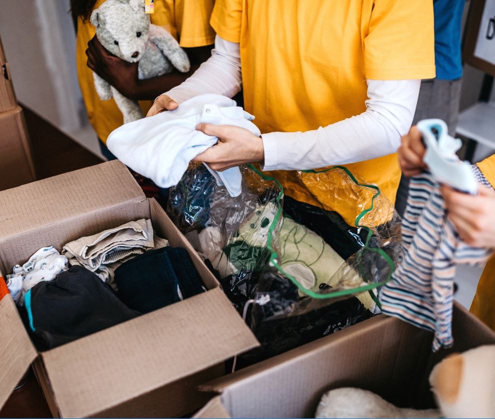 Volunteers packing boxes of clothes for donation