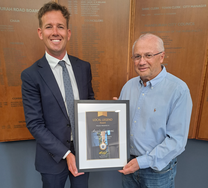 Angelo Gangemi and Mayor Rhys Williams stand side by side with award