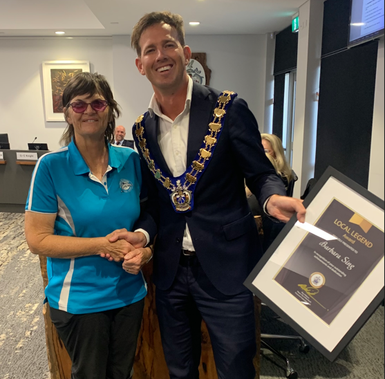 Mayor and Barbara shake hands and hold certificate