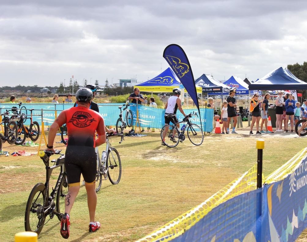 Man gets on his bike for triathlon race outdoors