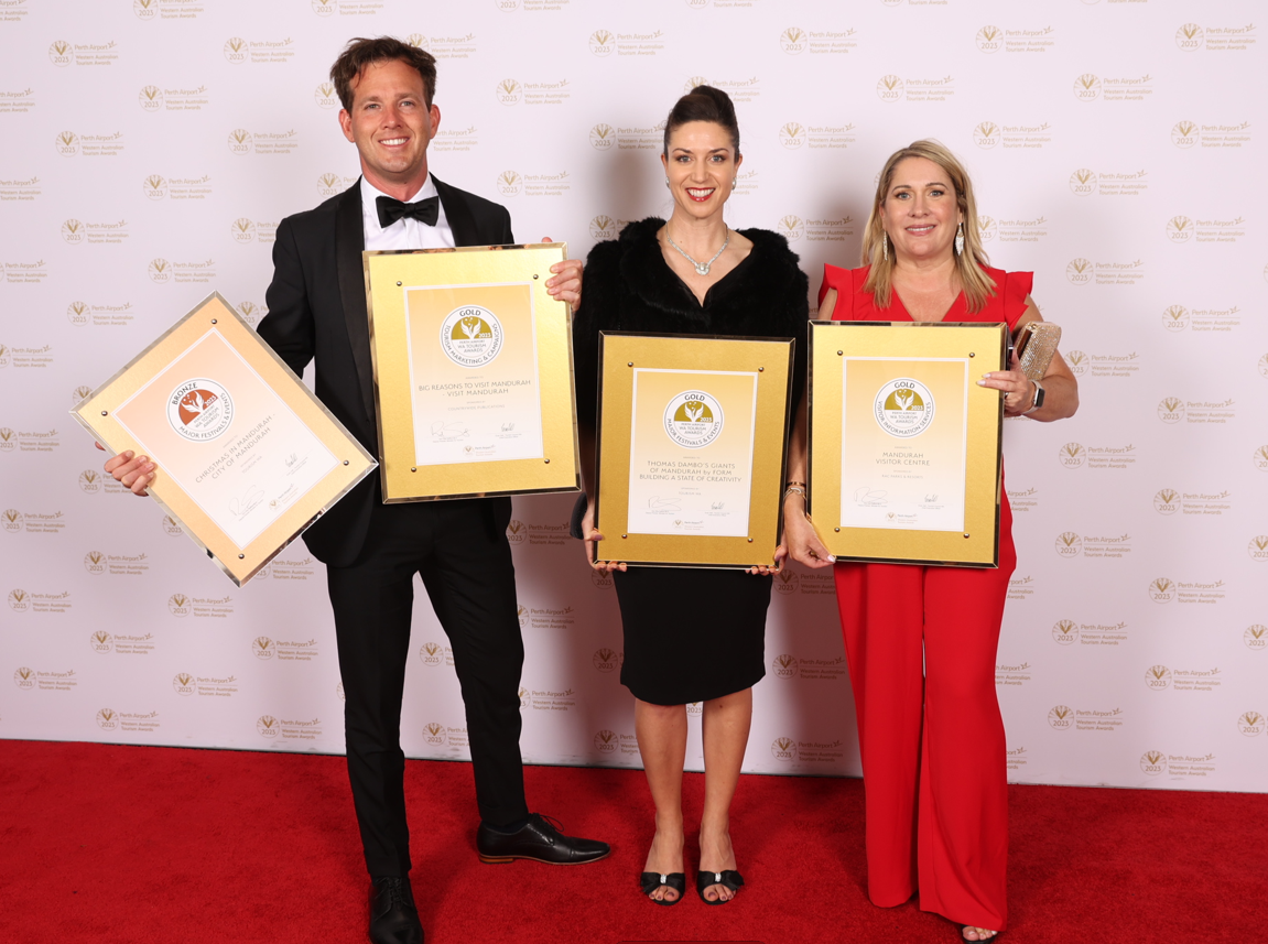 Mayor Rhys Williams, Tabitha McMullan and Anita Kane side by side holding awards