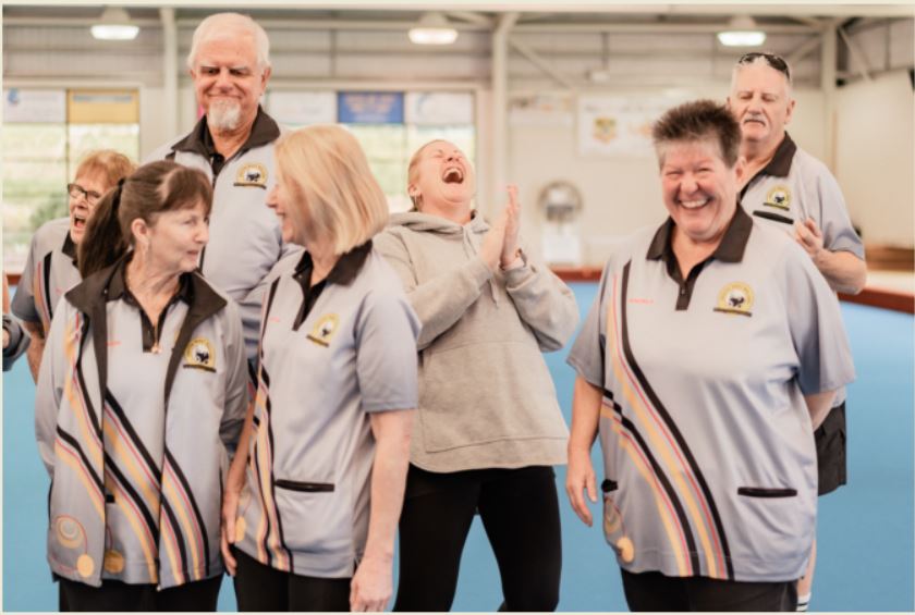 Candid photo of Bowls players laughing in a group