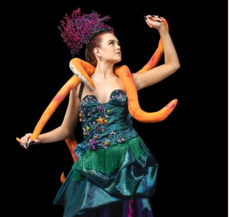 Model wears Wearable Art Mandurah garment with long orange tentacles and blue bodice