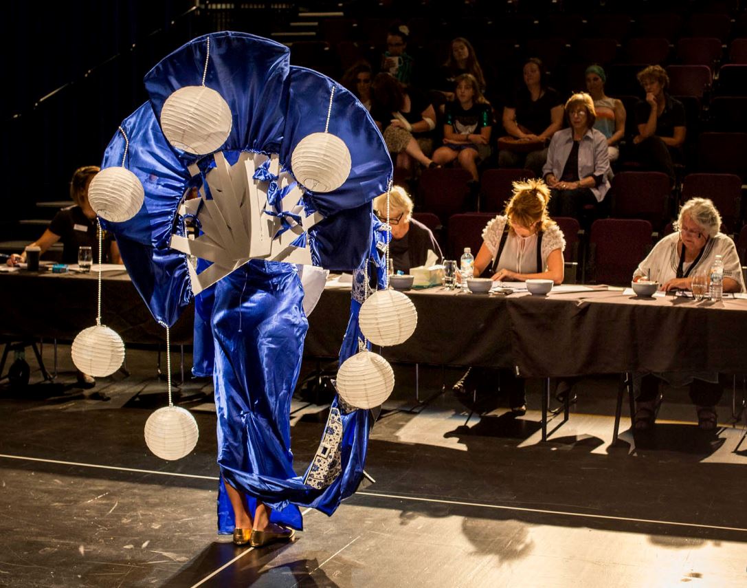 A Wearable Art creation on stage, in front of judging panel