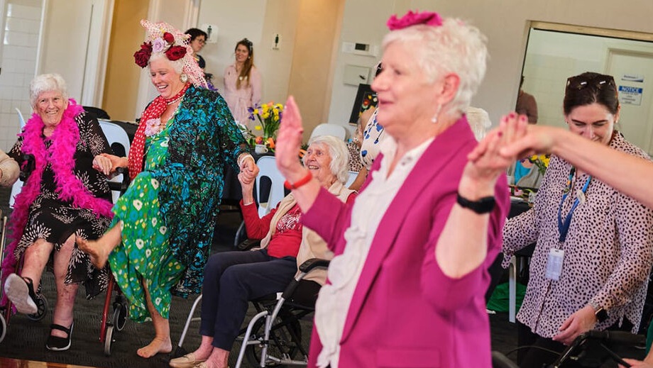 A group of senior women dancing at The Creative Age celebration.