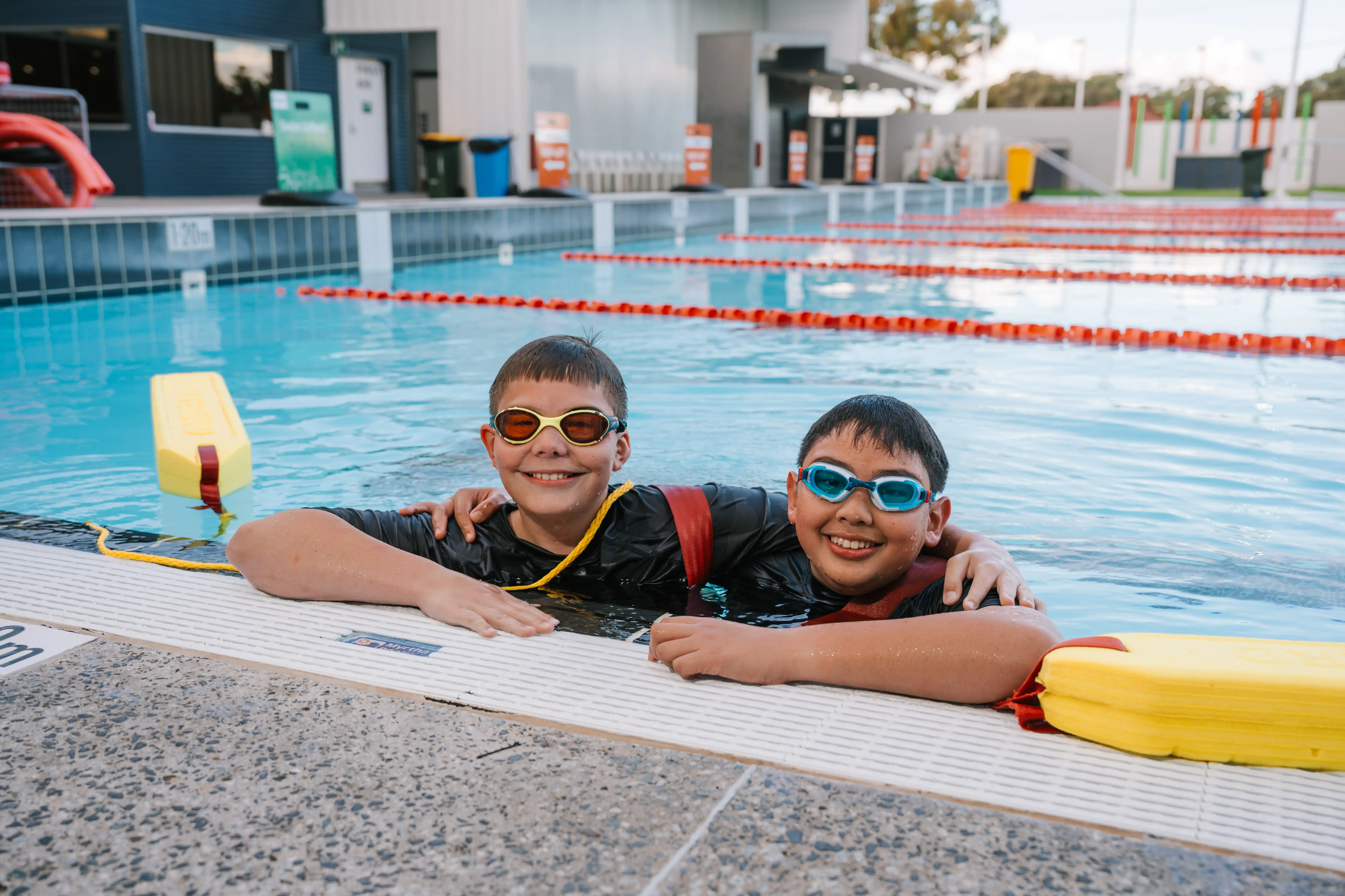 Two children in pool for lifeguard lessons.