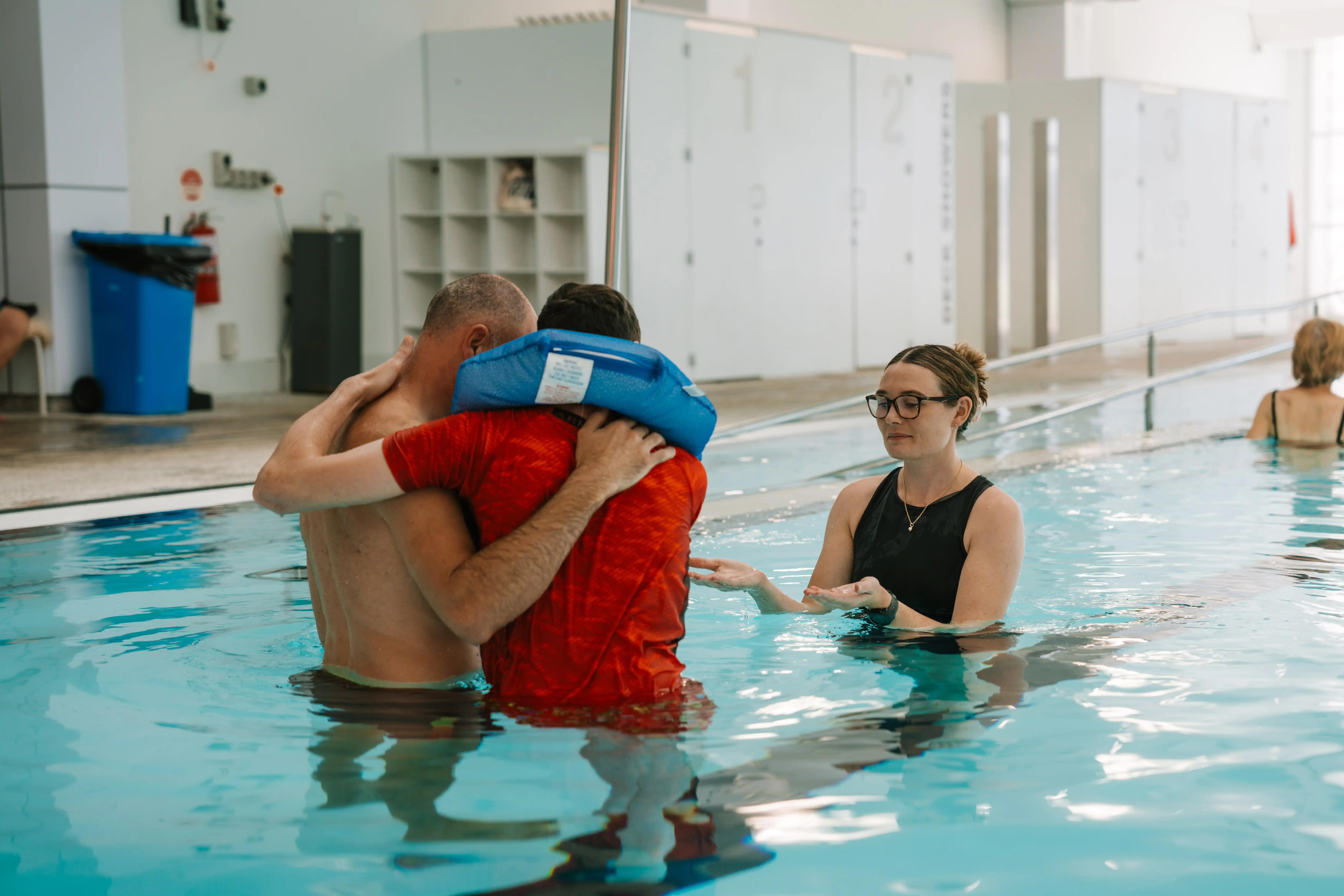 Person being supported to learn to swim.