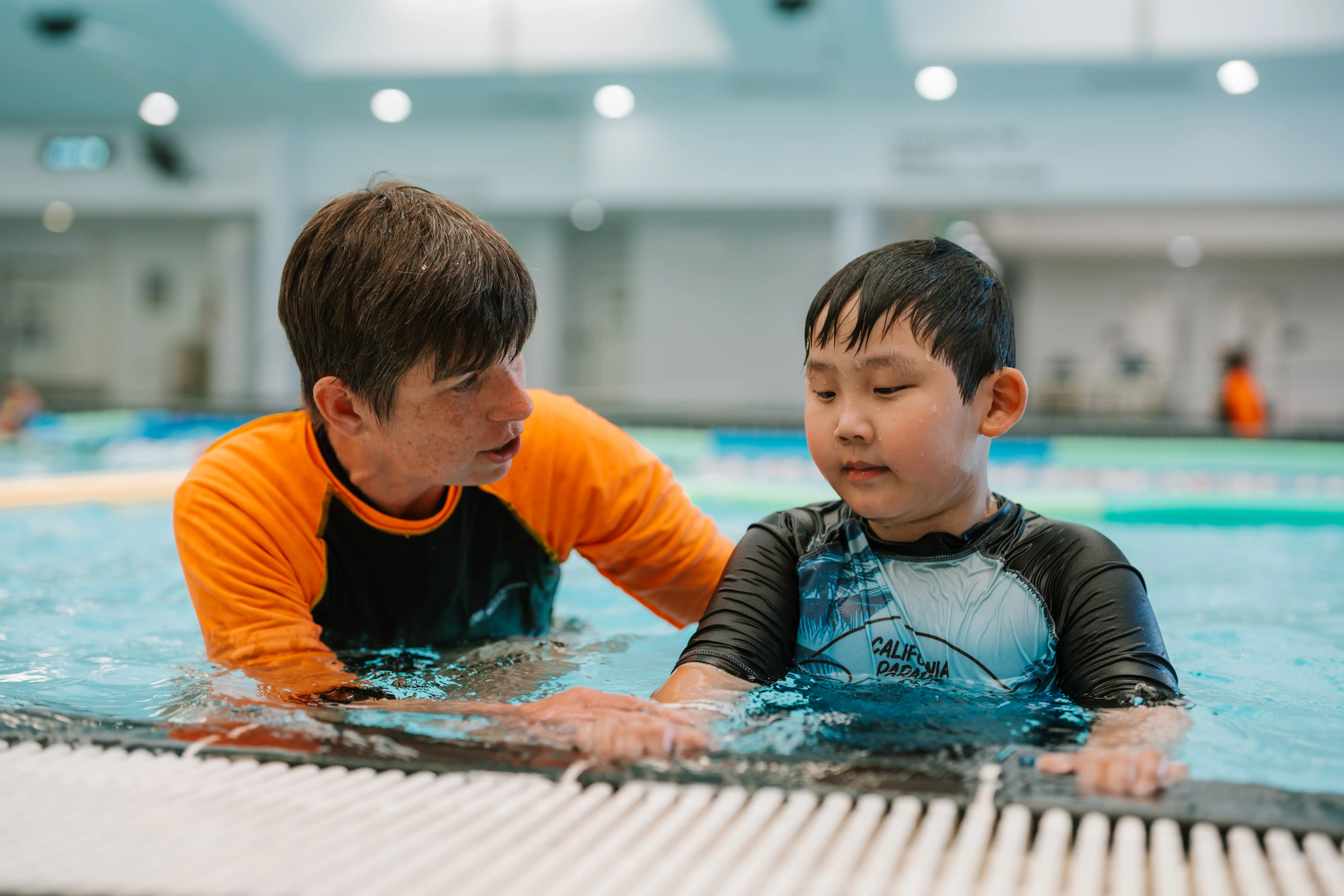 Child with swim teacher in swim lesson.